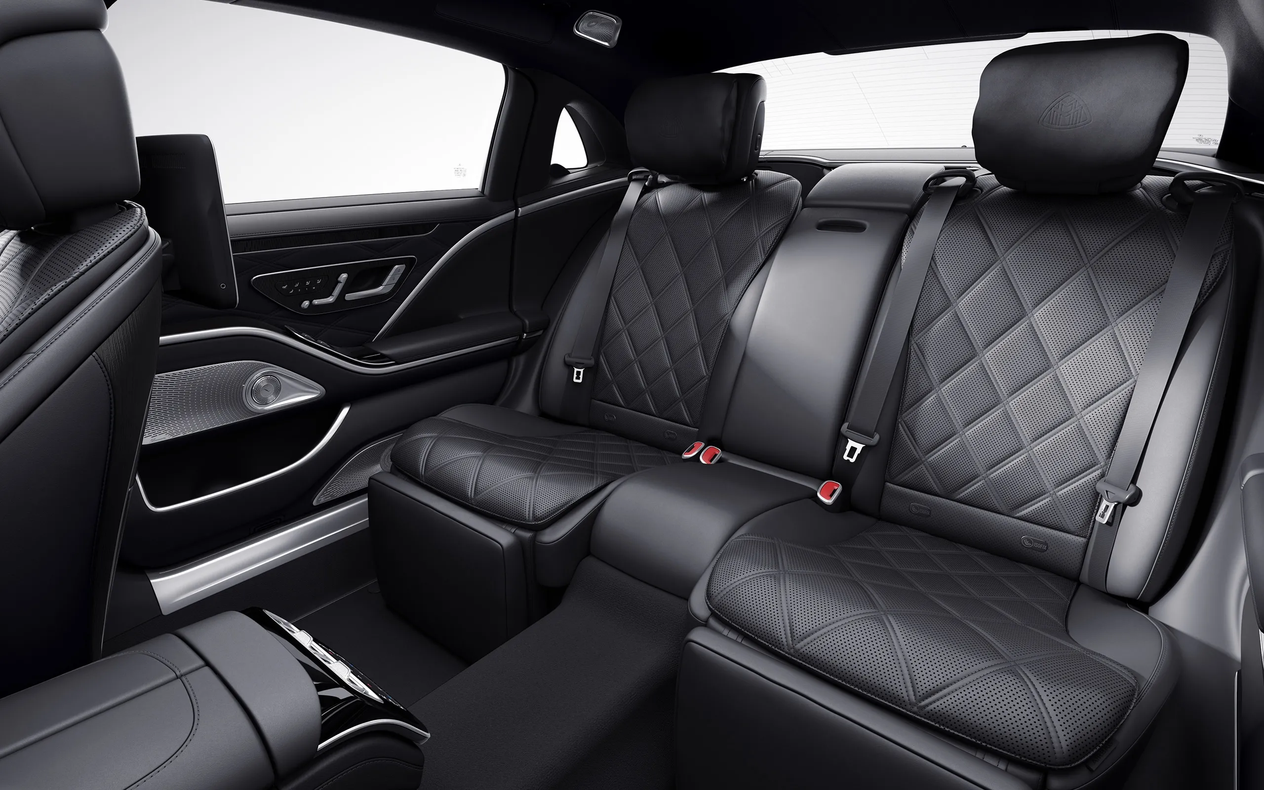 A car with black leather seats and the back seat folded down.