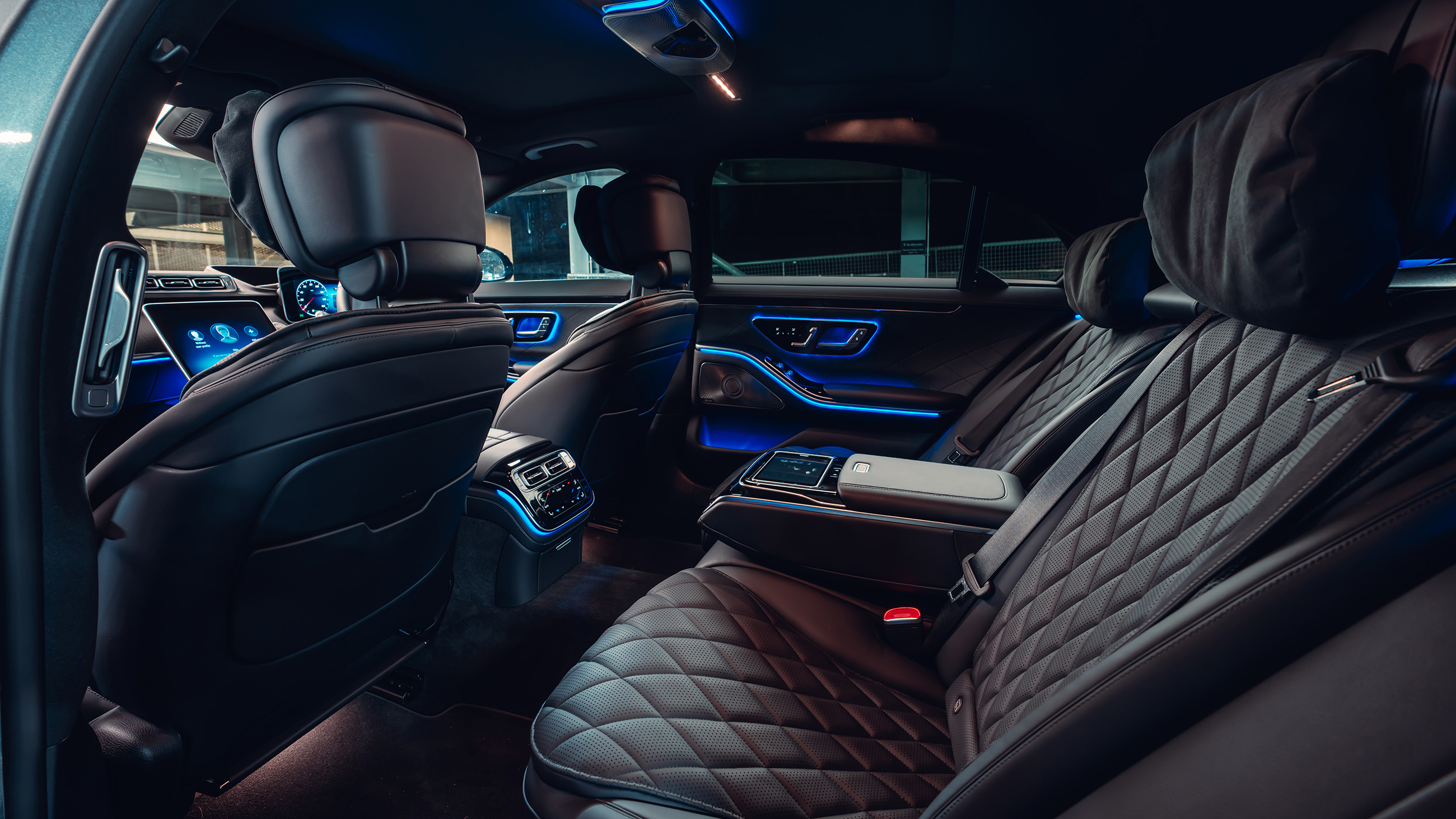 A car with black leather seats and blue lights.