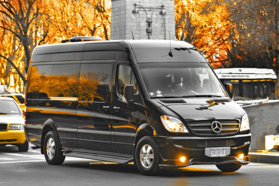 A black van is parked on the street