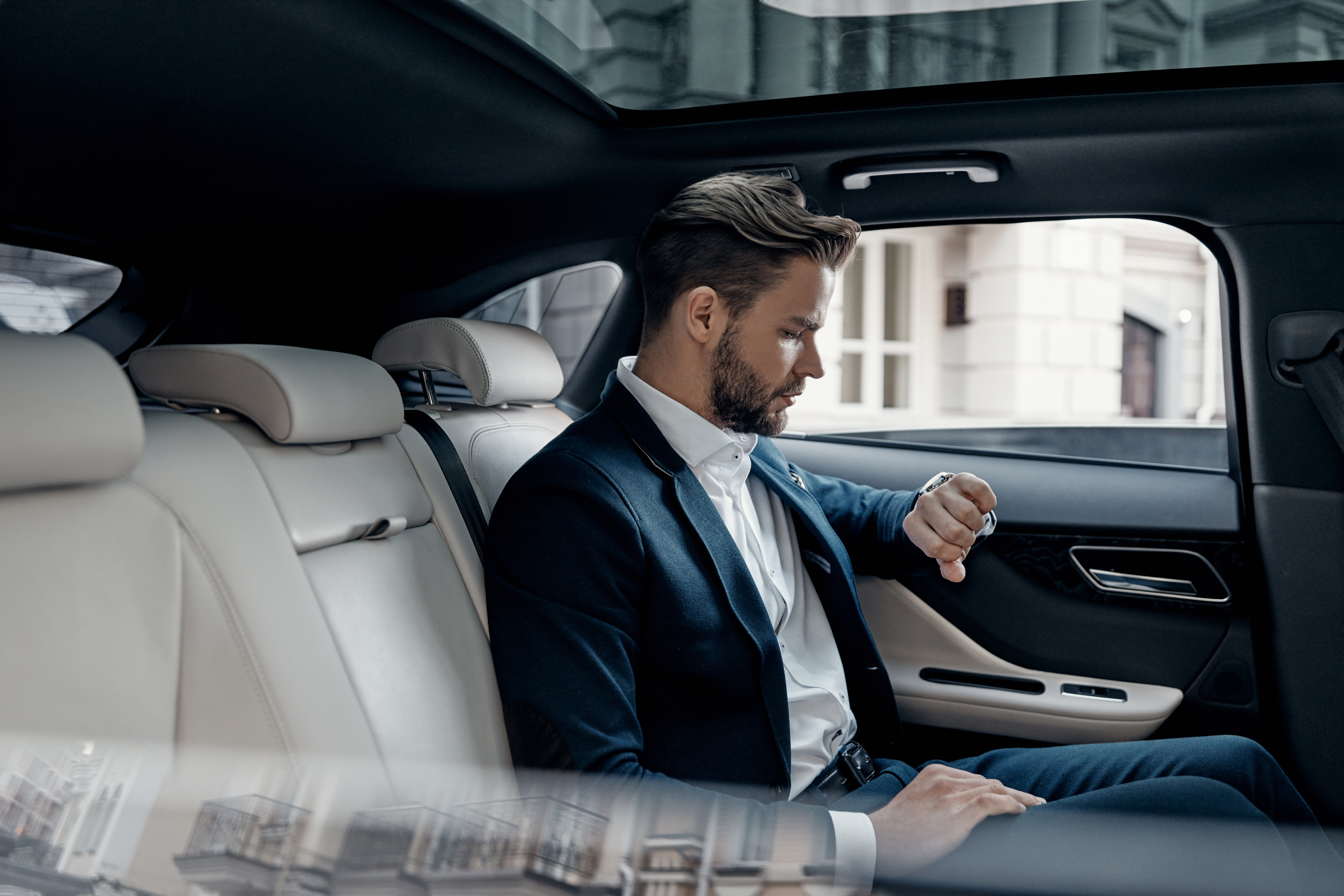 A man sitting in the back of a car